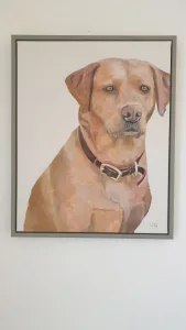 Painting of a dog framed by world under glass