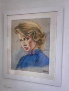 Female portrait in oil pastel framed by world under glass
